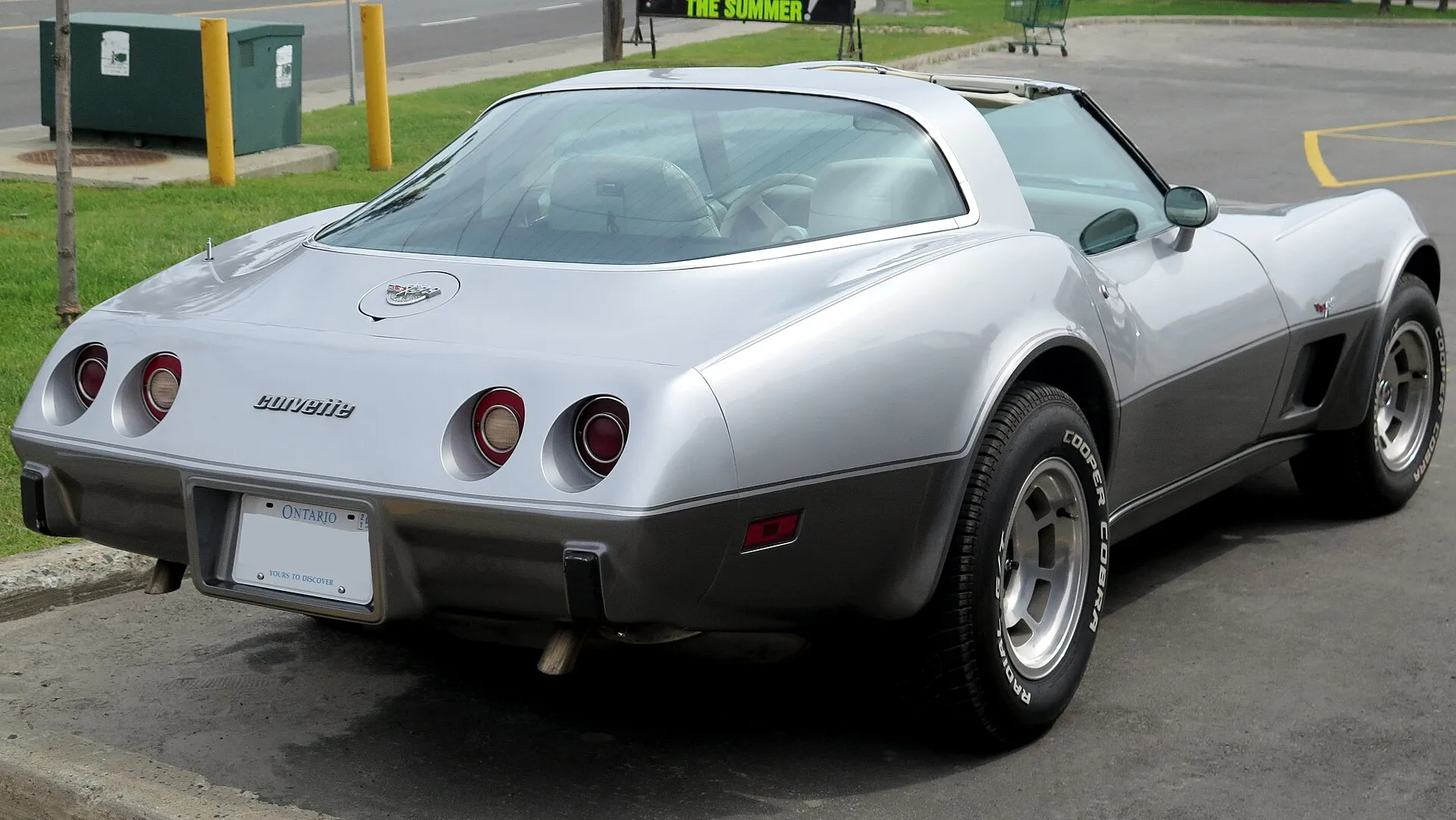 The rear of a two-tone silver 1978 Corvette Silver Anniversary coupe, showing the large fastback rear window.