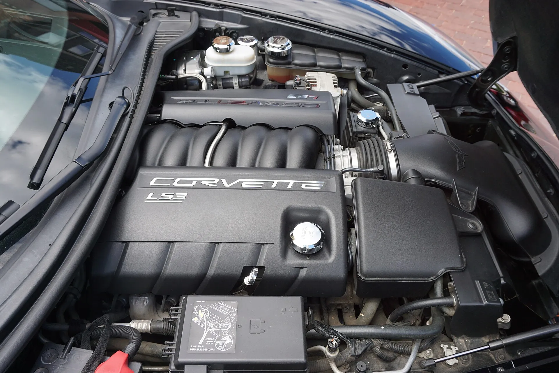 Engine bay of a 2011 Chevrolet Corvette showing the LS3 engine cover and air intake