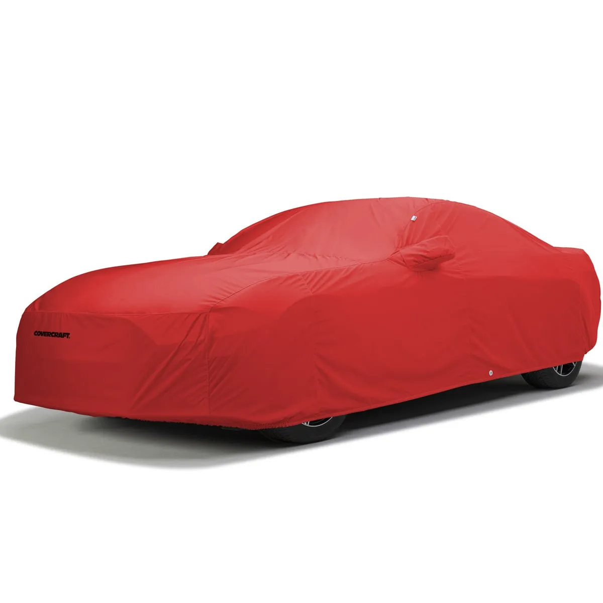 A red Covercraft WeatherShield HP cover over a coupe, with a mirror pocket, a tie-down grommet near the rear wheel and the Covercraft name on the front corner.